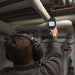 Man calibrating the pipe with Leak Detector on hand